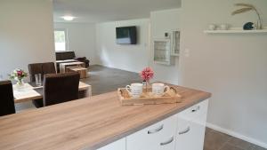 a kitchen and living room with a wooden counter top at Die Fünf in Brodersby