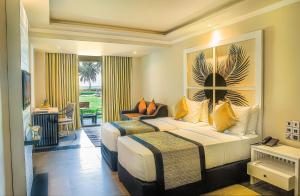 a hotel room with two beds and a balcony at Earl's Reef in Bentota +59 photos