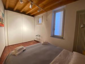 a bedroom with a bed with two towels on it at CASA HERMES in Bergamo