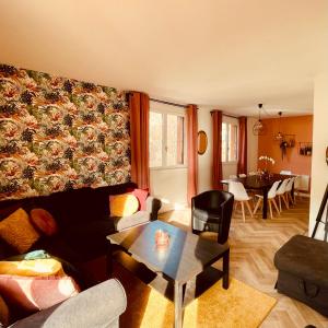 a living room with a couch and a table at L'Ekrin des Cimes in Le Mont-Dore