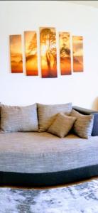 a couch with several pillows on it in a room at Bismarck Apartment in Pirmasens