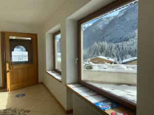 a room with a window with a view of a mountain at Hotel Pizboè in Mazzin