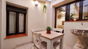 a kitchen with a table and a sink in a room at Las cuevas del agua in Chinchón