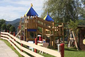 a playground in a park with a fence at Hotel Pariente in Schladming