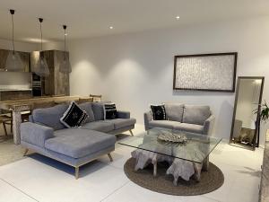 a living room with two couches and a glass table at AURA AIR 1, pool & seaview villa, Choengmon 500m in Koh Samui 