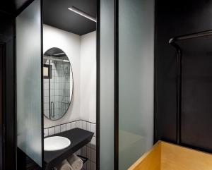 a bathroom with a sink and a mirror at NUO By juSTa in New Delhi