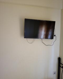 a flat screen tv hanging on a wall at Athanasiadis Studios in Nea Vrasna