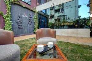 a chair and a coffee table in front of a building at Elite Homes in Aurangabad