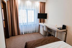Ένα ή περισσότερα κρεβάτια σε δωμάτιο στο Usadba Berezino