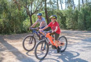 a man and a young boy riding bikes at Pigna Felice Punta Ala in Punta Ala