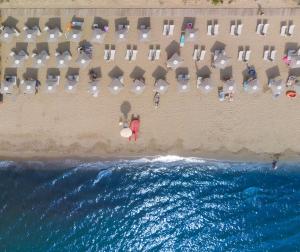 an overhead view of a beach with chairs and people at Pigna Felice Punta Ala in Punta Ala