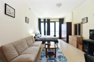 a living room with a couch and a table at Studio in JLT X1 Tower close to Metro - DB in Dubai