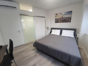 a bedroom with a bed with two white pillows at Hotel FeWo-HM in Ramstein-Miesenbach