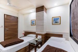 Postel nebo postele na pokoji v ubytování Hotel Ashish
