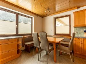 a dining room with a wooden table and chairs at Cosy holiday home in a charming area in Muhr