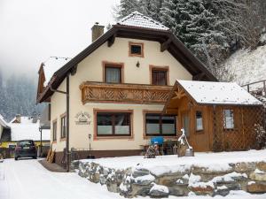 a house with snow on the ground in front of it at Cosy holiday home in a charming area in Muhr