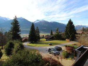 a car parked in a parking lot with mountains in the background at Charming Chalet in Niedernsill near Ski Area in Niedernsill