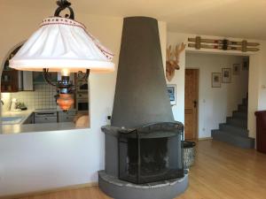 a stove in a living room with a lamp at Chalet in Maria Alm in ski area with sauna in Maria Alm am Steinernen Meer