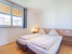 a bedroom with two beds and a window at Apartment in St Margarethen with balcony in Sankt Margarethen im Lungau