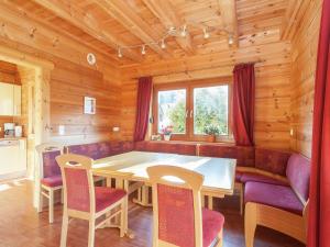 a dining room with a table and chairs at Chalet in Sankt Margarethen with sauna in Sankt Margarethen im Lungau