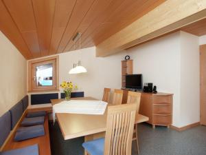 a dining room with a table and chairs at Lush Apartment in Silbertal with Garden in Silbertal