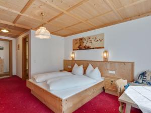 a bedroom with a large bed with white pillows at Land on the KPPL mountain chains in Kappl