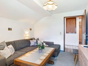 a living room with a couch and a table at Cozy Farmhouse in Oetz near Ski Area in Sautens