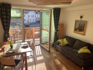 a living room with a couch and a table at Cèsa Mia in Campitello di Fassa