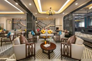 a lobby of a hotel with couches and tables at DeLaSol Sapa Hotel in Sa Pa