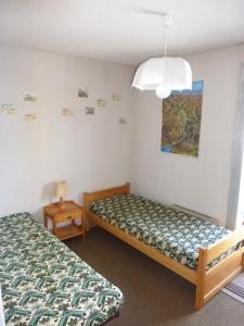 Ένα ή περισσότερα κρεβάτια σε δωμάτιο στο Manettes 14