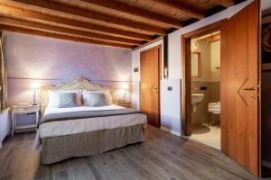 a bedroom with a bed and a dresser at Ca' Fontanea in Venice