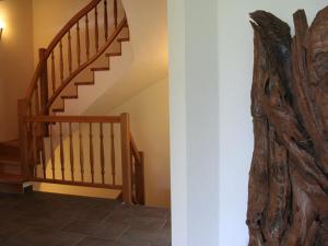a staircase in a house with a wooden stair case at Luxurious holiday home with terrace in Tyrol in Brixen im Thale