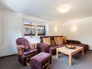 ein Wohnzimmer mit einem Sofa, 2 Stühlen und einem Tisch in der Unterkunft House in H ttau near Salzburg Airport in Hüttau