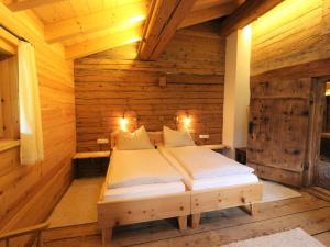 um quarto com uma cama num quarto de madeira em Chalet on the ski slope in St Johann in Tyrol em Apfeldorf