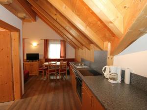 a kitchen with wooden ceilings and a dining room at Quaint Apartment in L ngenfeld with Sauna in Huben
