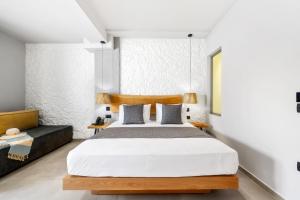a bedroom with a large bed and a couch at Emily's Luxury Suites in Pefkochori