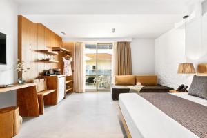 a hotel room with a bed and a living room at Emily's Luxury Suites in Pefkochori
