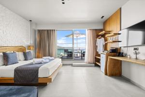 a bedroom with a bed and a view of the ocean at Emily's Luxury Suites in Pefkochori