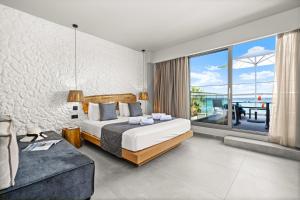 a bedroom with a bed and a view of the ocean at Emily's Luxury Suites in Pefkochori