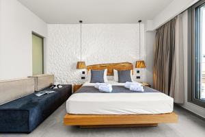 a bedroom with a large bed and a couch at Emily's Luxury Suites in Pefkochori