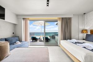 a bedroom with a bed and a view of the ocean at Emily's Luxury Suites in Pefkochori