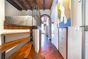 a hallway with a wooden staircase in a house at Porta Romana & Bocconi Cosy Apartment in Milan