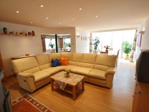 a living room with a couch and a table at Holiday Home in Salzburg near Ski Area with Balcony in Fusch an der Glocknerstraße