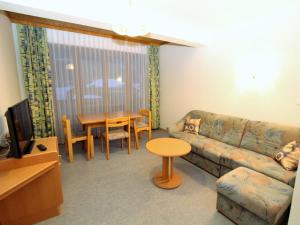 a living room with a couch and a table at Cosy Apartment in Weissensee near Ski Lift in Weissensee