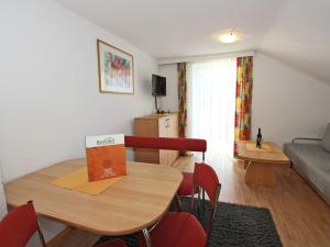 a living room with a table and chairs and a couch at Chalet in Fiss near Ski Lifts in Fiss