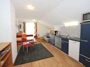 a kitchen and living room with a table and chairs at Chalet in Fiss near Ski Lifts in Fiss +15 photos