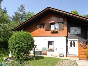 a small house with a wooden roof at Apartment in Wernberg in Carinthia with pool in Wernberg
