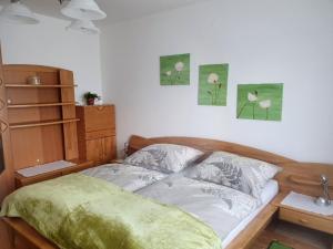 a bedroom with a bed and some pictures on the wall at Holiday home in Altmelon in the Waldviertel near Vienna in Altmelon