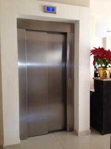 a stainless steel elevator door in a room at Hotel Madrid in Tuxtla Gutiérrez
