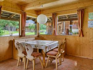 a dining room with a wooden table and chairs at Chalet in Sankt Georgen near ski area in Sankt Georgen ob Murau